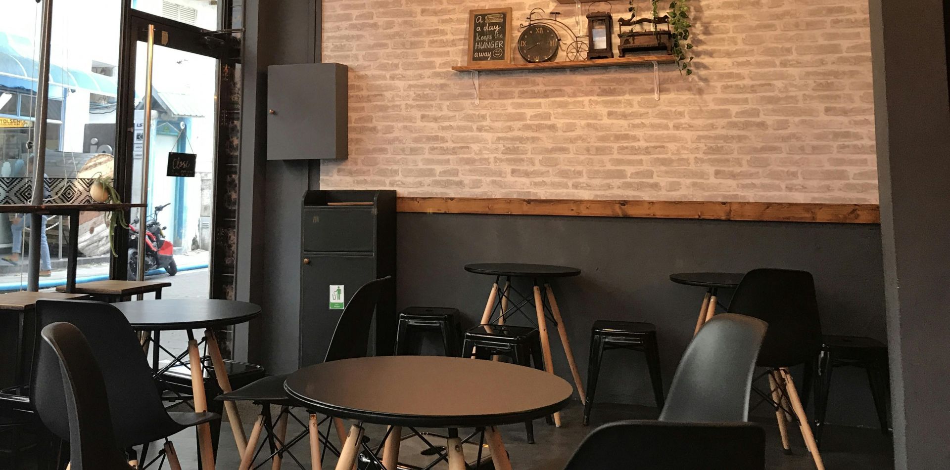 A stylish cafe interior featuring modern furniture and ambient lighting for a cozy atmosphere.